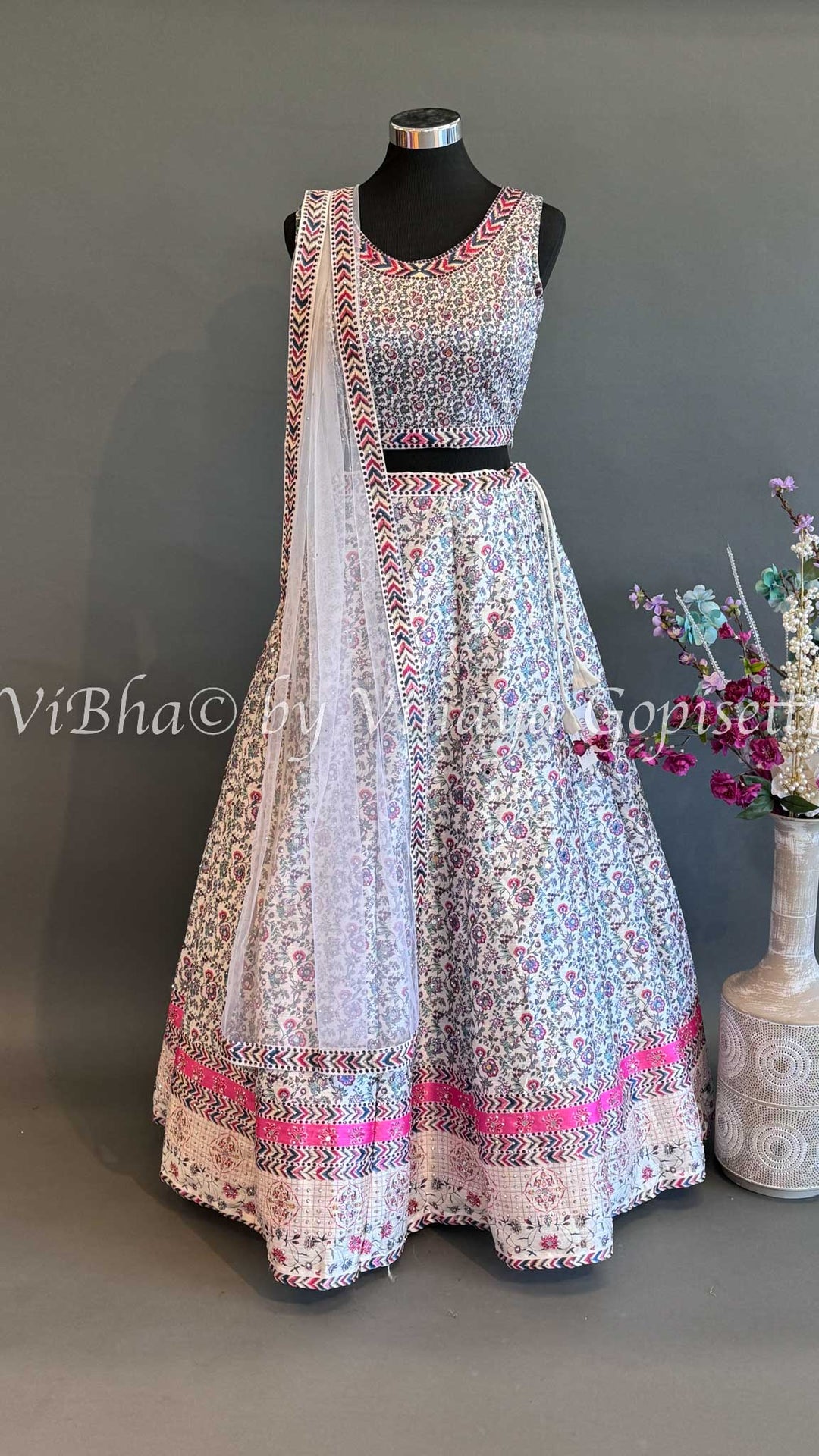 Ivory Lehenga With Pink and Blue thread embroidered work.