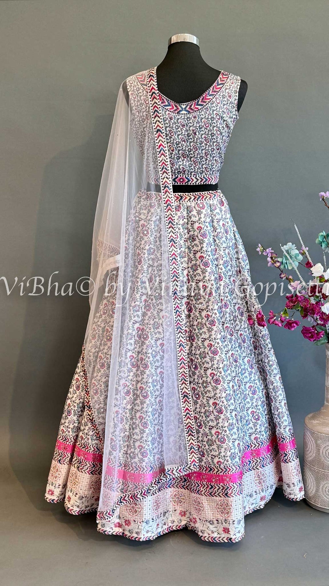 Ivory Lehenga With Pink and Blue thread embroidered work.