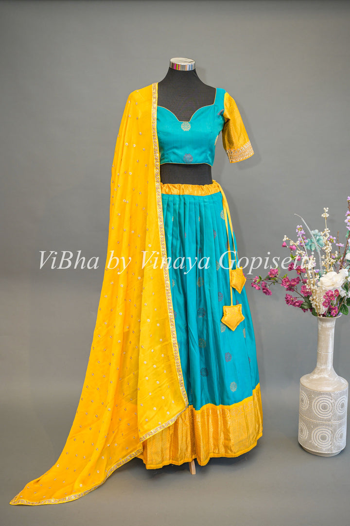 Teal Blue and Yellow Gadwal Silk Lehenga With Embroidered Hemline Of The Sleeves.
