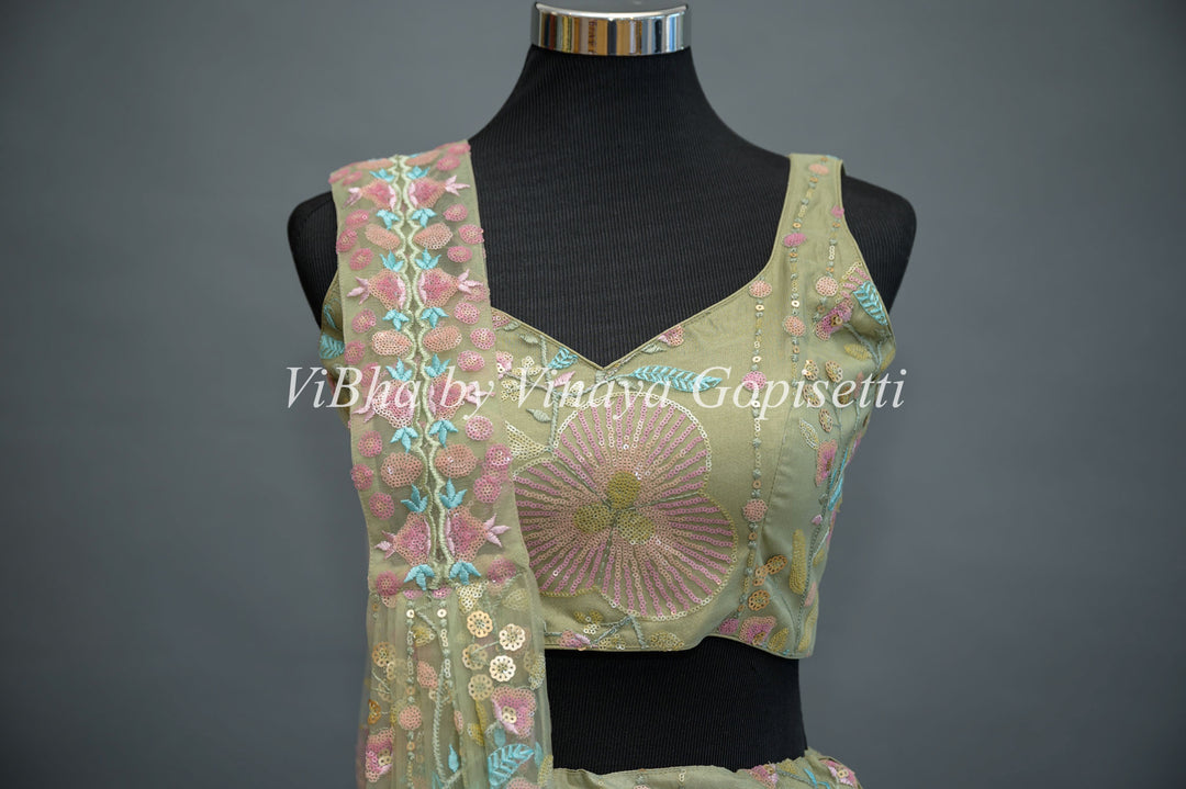 Pastel Green Net embroidered Lehenga Set With Sleeveless Blouse