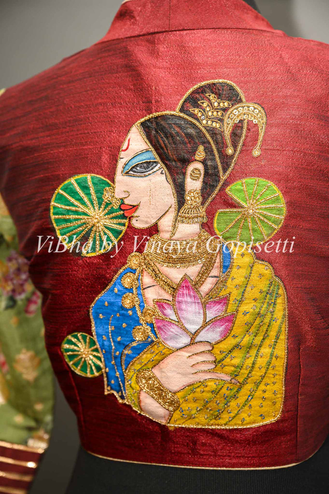 Maroon hand painted blouse with embroidery and floral sleeves.
