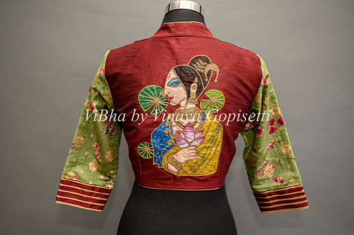 Maroon hand painted blouse with embroidery and floral sleeves.