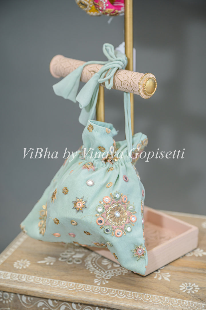 Pastel Blue Embroidered Sharara Set With Choker Dupatta And Matching Potli Bag