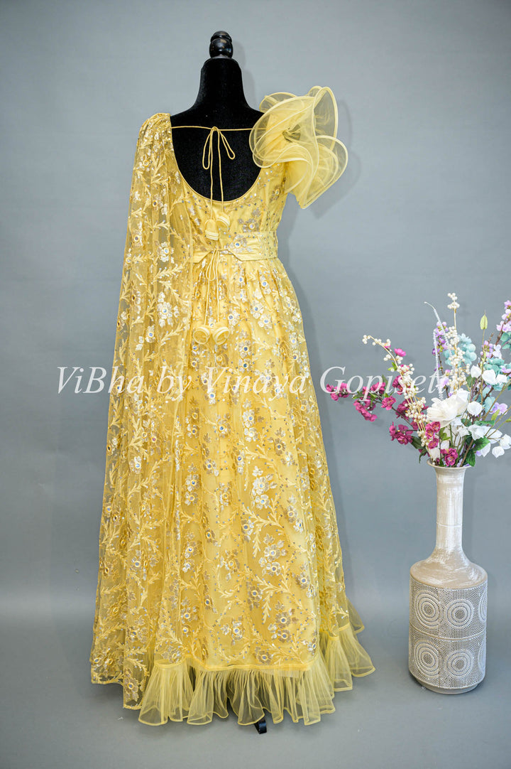 Yellow Net Embroidered One Side Cape Sleeve Gown With Waist Belt