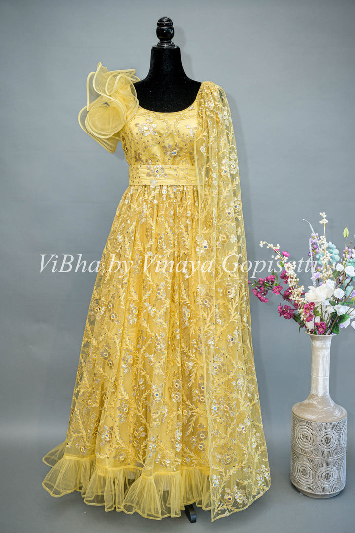 Yellow Net Embroidered One Side Cape Sleeve Gown With Waist Belt